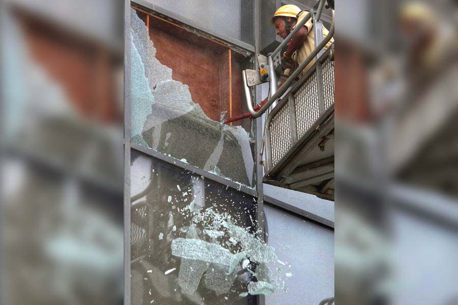 A firefighter smashed portion of the glass facade at Acropolis mall only to find out plywood panels blocking his access to let the smoke out