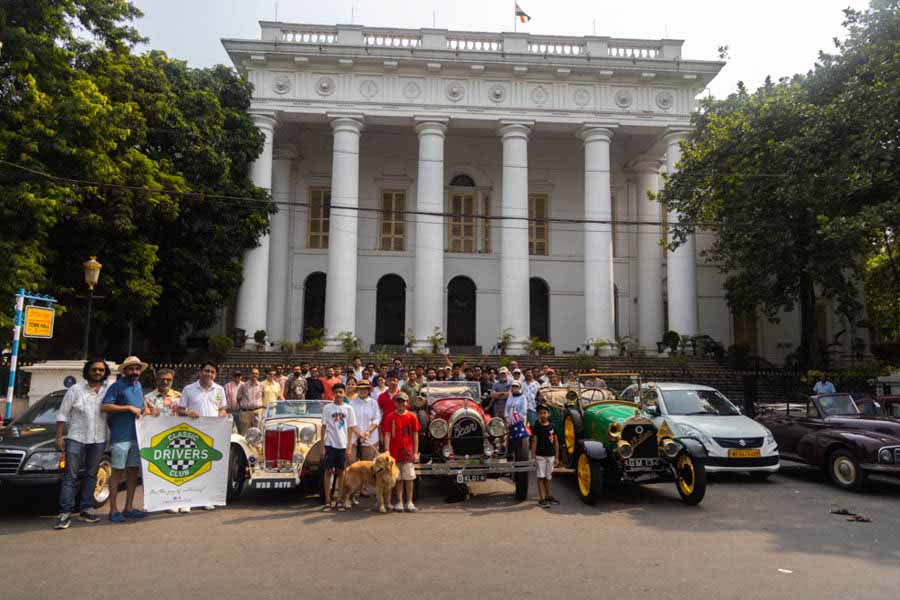 The Kidbys and members of Classic Drivers Club in front of Town Hall.