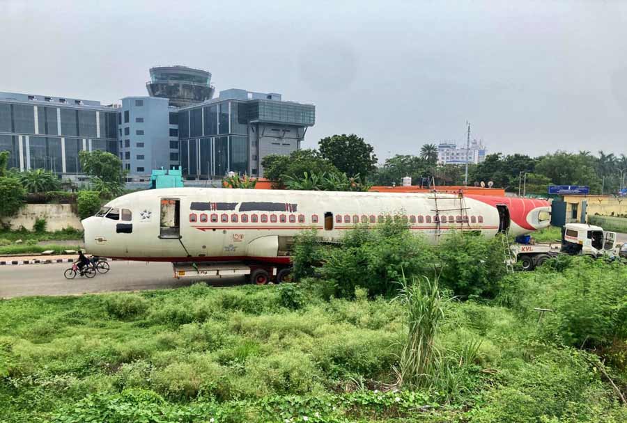 A scrap airplane is being transported by truck near Airport in Kolkata  