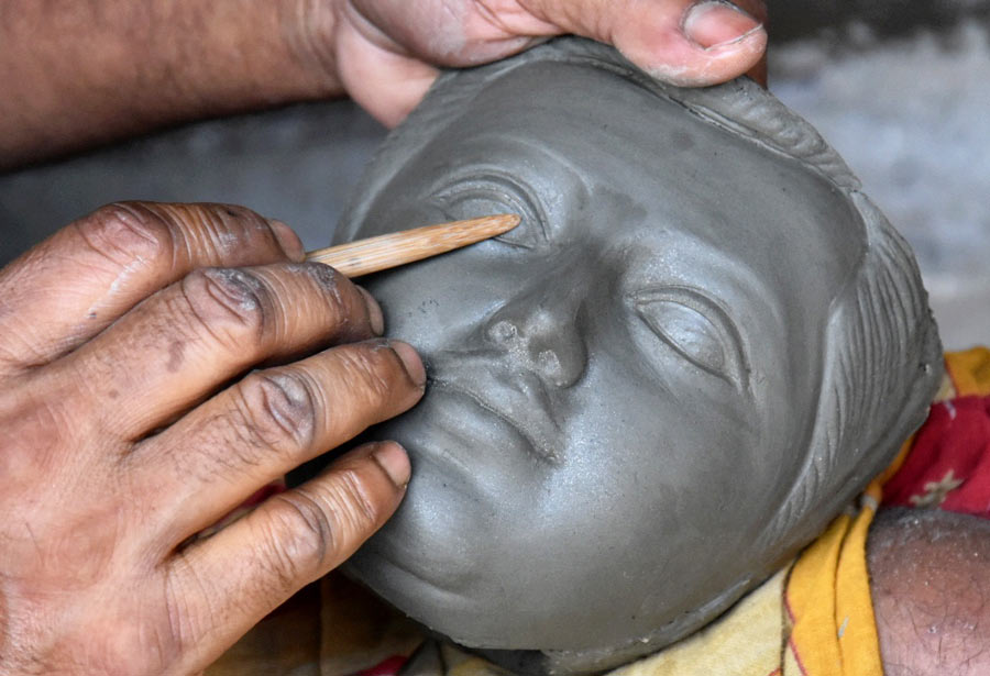 An artisan works on a Durga idol’s face in Kumartuli on Wednesday. Counting from Sunday, Durga Puja is about 101 days away  