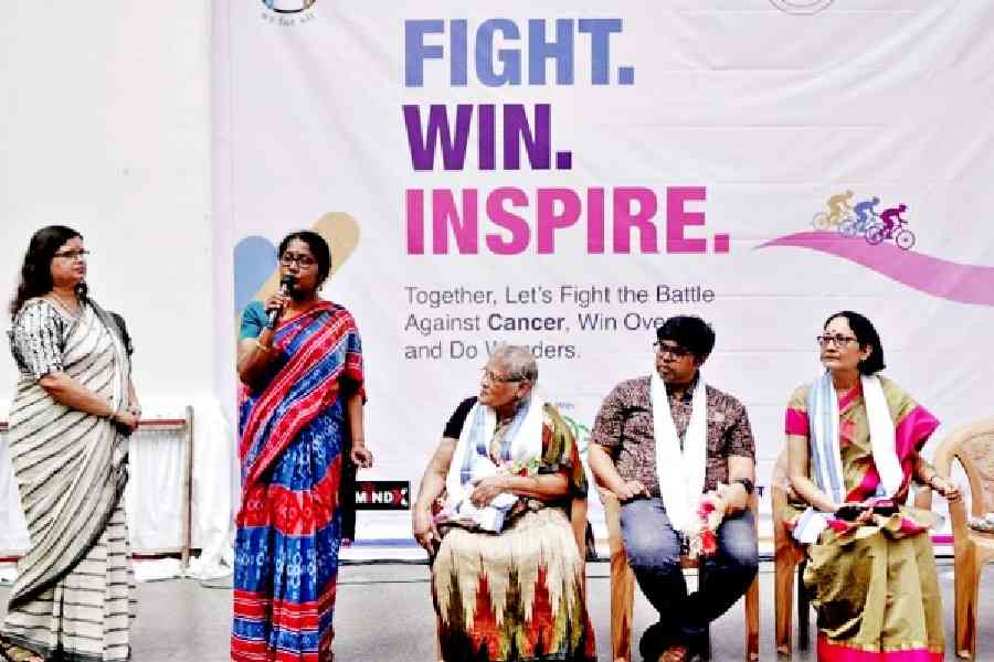 A family member of a cancer survivor speaks to the audience at Nazrul Tirtha