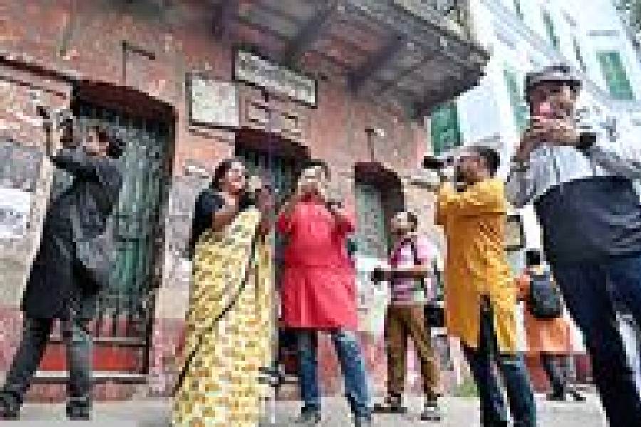 Some of the photographers in front of Tapan Theatre on Sadananda Road on Sunday