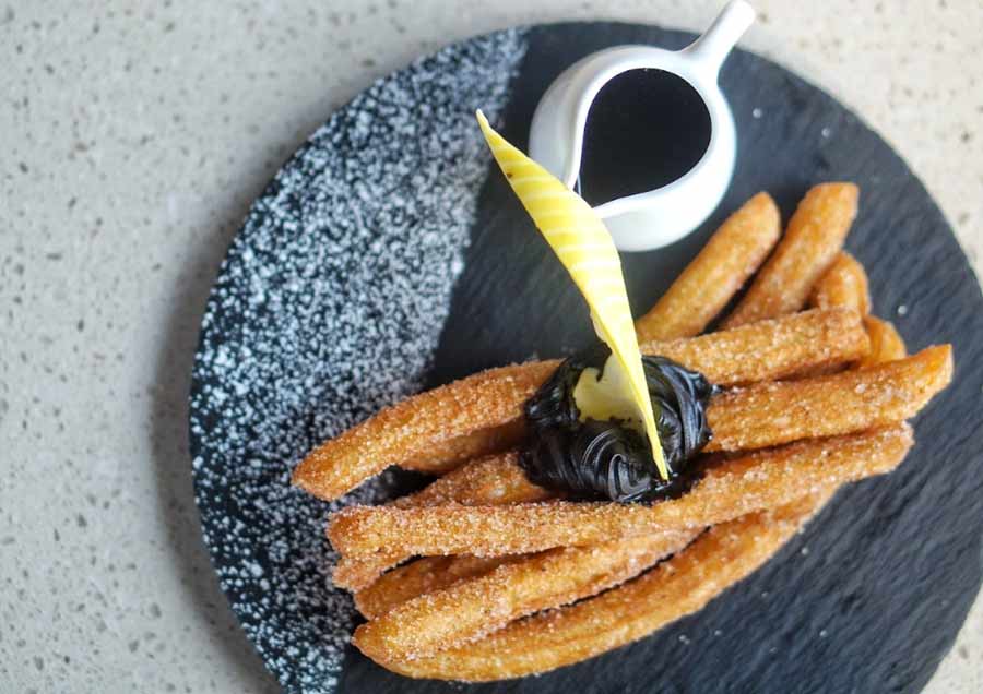 Indulge in the sweeter side of life with the Churros, which comes with a rich chocolate dip and is delicately coated in cinnamon sugar