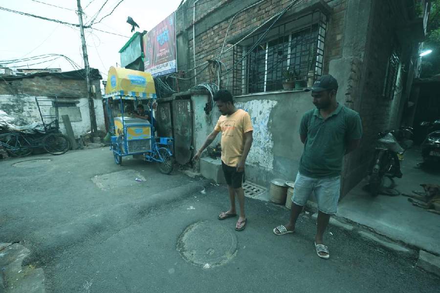 Brothers Subun and Bubun Haldar (in green t-shirt) show the spot in front of their house in Behala where they were allegedly assaulted.