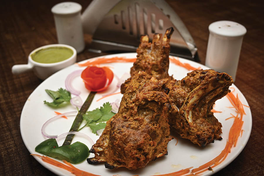 Their popular 'Adrak Ke Panje' features meaty goat ribs marinated in thick layers of yoghurt, crushed spices, nuts and ginger-garlic paste that falls off the bone when served piping hot from the tandoor