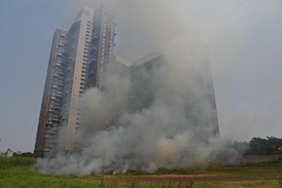 Smoke rises from a vacant plot behind JW Marriott on Tuesday