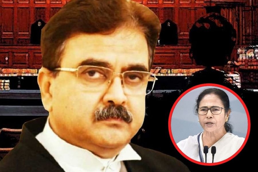 Abhijit Gangopadhyay (left) with the BJP flag at the party’s Salt Lake office in Calcutta on Thursday.