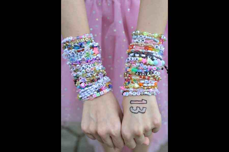 A Taylor Swift fan from Bangkok poses with her friendship bracelets at the National Stadium on the first night of Taylor Swift's Eras Tour concert in Singapore
