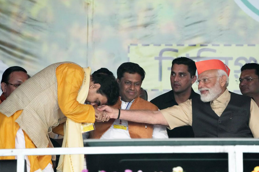 Prime Minister Narendra Modi being greeted by ex-judge Abhijit Gangopadhyay, who has joined BJP, during a public meeting at Kawakhali ground, in Siliguri, Saturday, March 9, 2024.