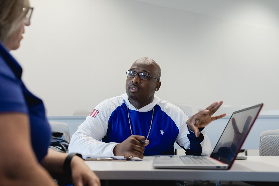 Jofama Coleman, who was recently exonerated from his conviction in a drive-by shooting in 2003, speaks with a professor in his Politics and Public Policy class at the University of California, Riverside, in Riverside, Calif., March 7, 2024. Coleman plans to earn a law degree and then work on wrongful convictions.