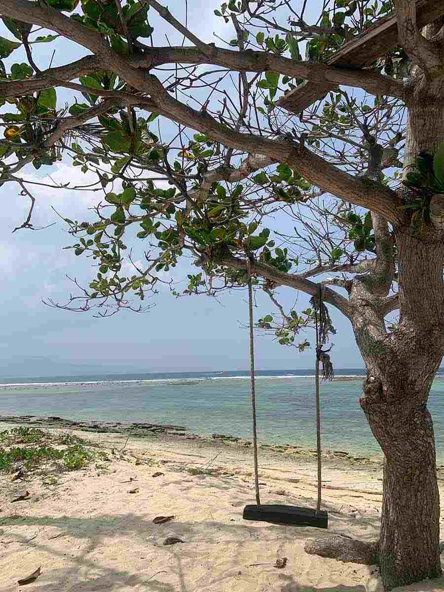 A lonely swing on the white beaches at Gili Meno