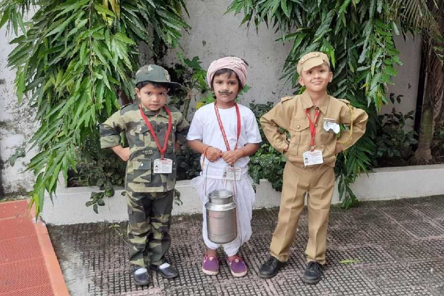 Children take part in a role play activity, dressing up as community helpers.