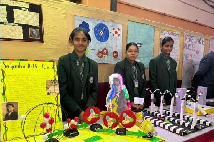 Students with an exhibit on Satyendra Nath Bose