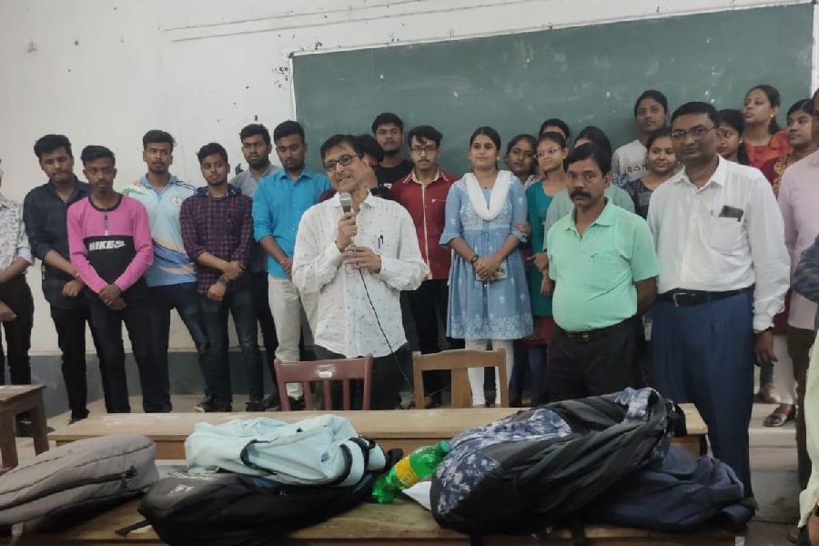 Khalisani Mahavidyalaya principal Arghya Bandyopadhyay (holding a microphone) poses with students, who have been recruited by IT major TCS, and a few non-teaching employees of the college in Chandernagore.