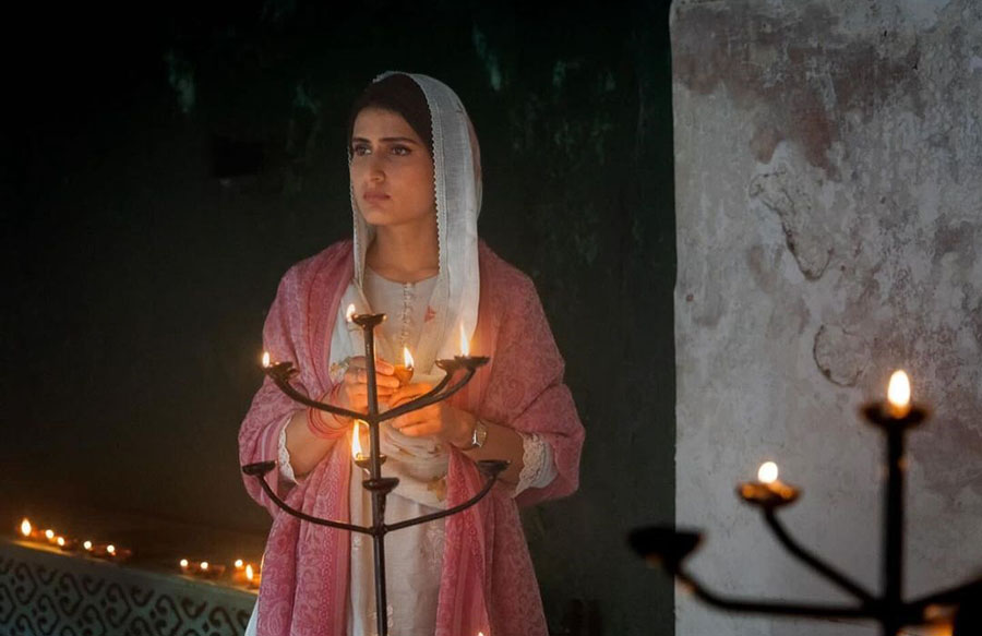 Fatima — known for her roles in Dangal, Sam Bahadur and Dhak Dhak — covers her head with a white dupatta and holds a diya, probably while celebrating a festival in the film.