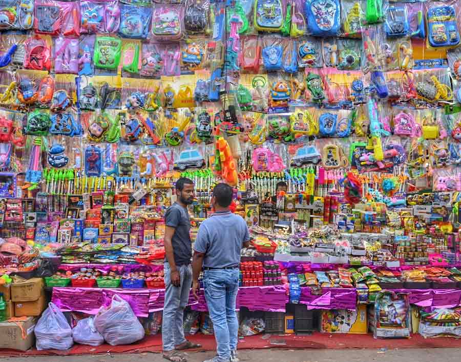 Shopkeepers selling gulal and water guns at Burrabazar on Tuesday ahead of Holi  