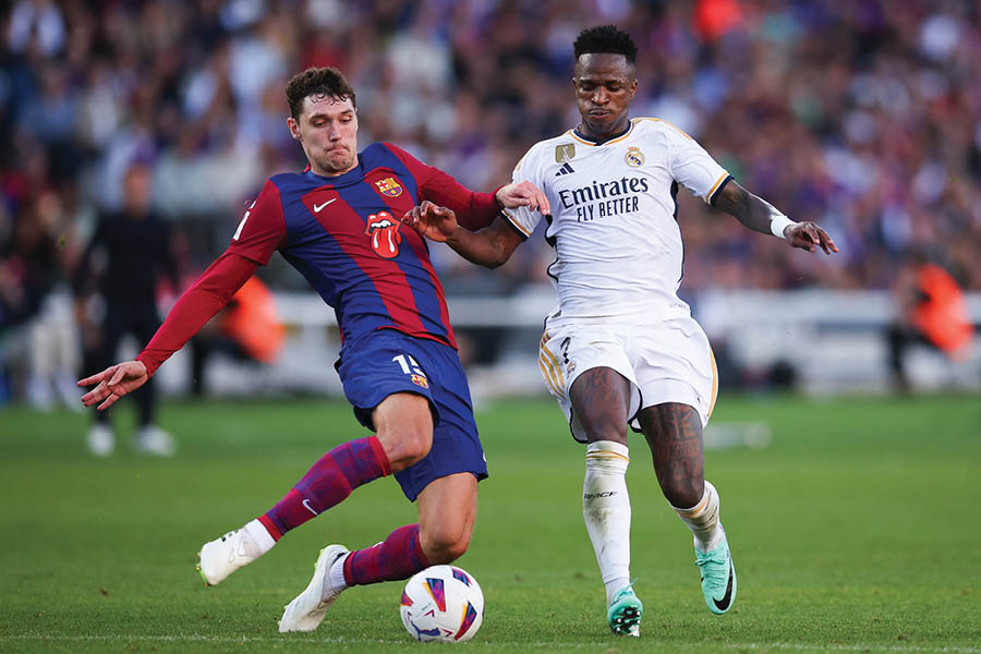 Andreas Christensen (left) of Barcelona vies for possession against Real Madrid’s Vinicius Junior during an El Clasico encounter in October 2023