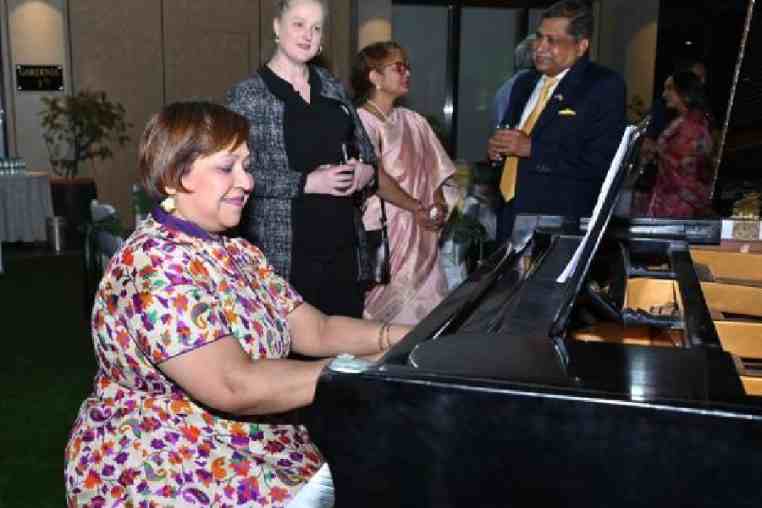 Rajlakshmi Syam plays the piano as American Center director Elizabeth Lee looks on