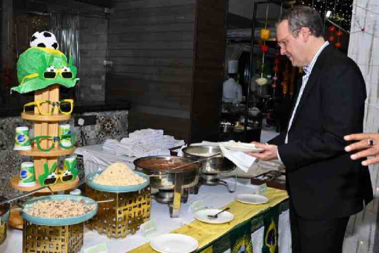 The ambassador checks out the Brazilian dishes