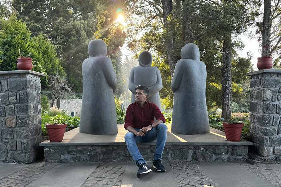The author poses by the stunning installation of three cowled monk statues