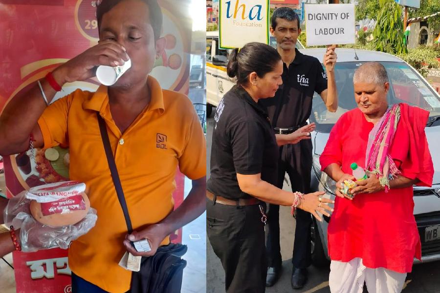 A delivery worker receives sherbet and rosogollas at KC Das on Wednesday;  AHA Foundation volunteer hands water and snacks to a porter at Howrah station (right)