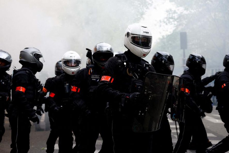 Police fired tear gas as thousands of protesters marched through the French capital