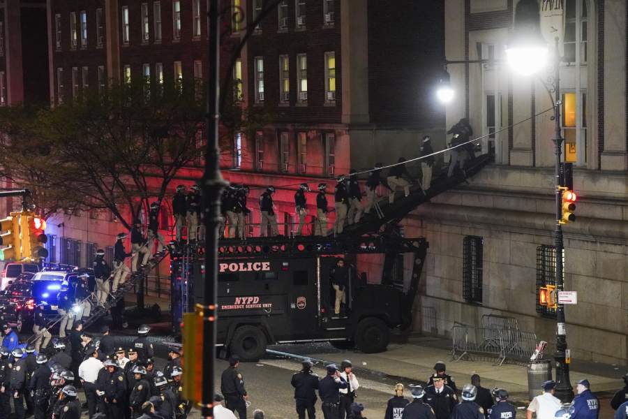 Police officers in riot gear enter Hamilton Hall at Columbia University on Tuesday night, April 30, 2024, to end the occupation of the building by pro-Palestinian demonstrators calling for an end to the war in Gaza.