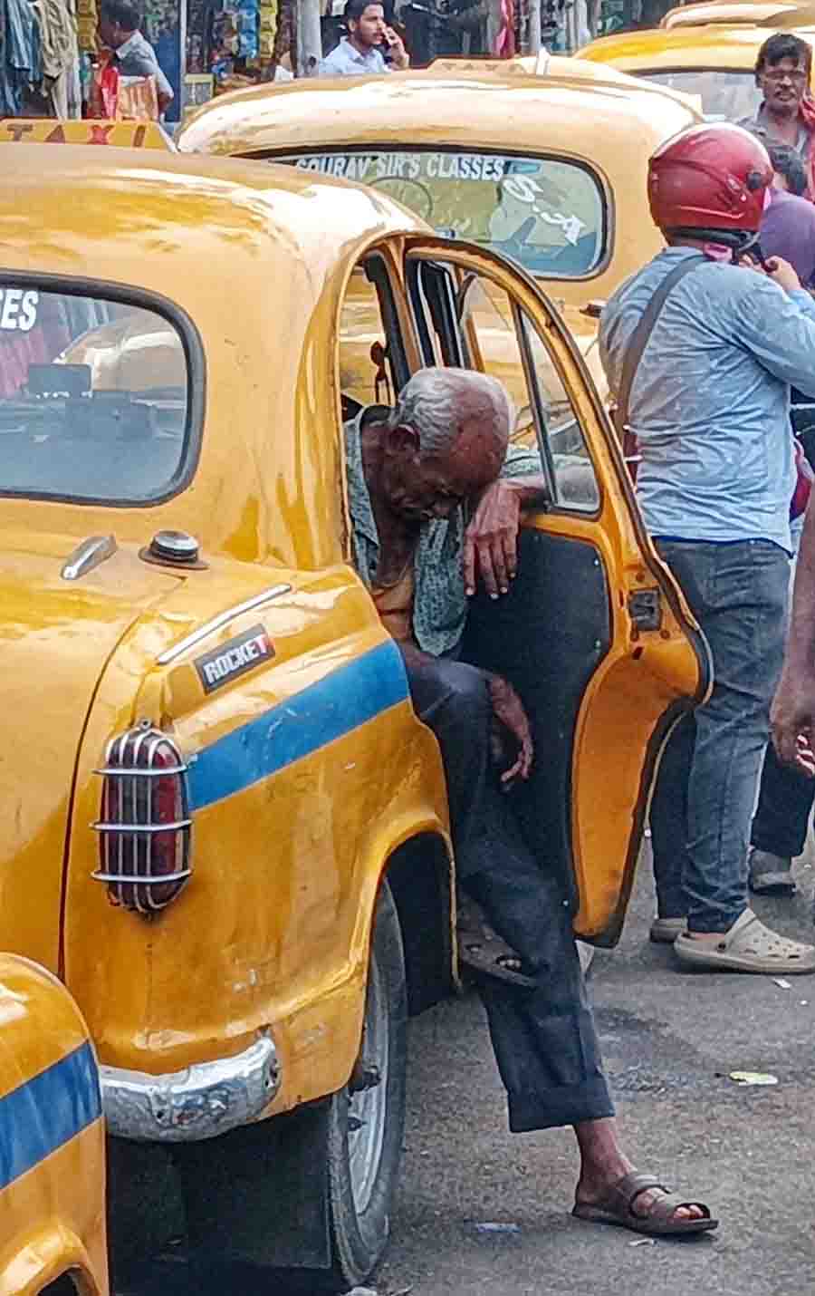 A cabbie dozes off on Saturday afternoon as business is lull owing to the heat