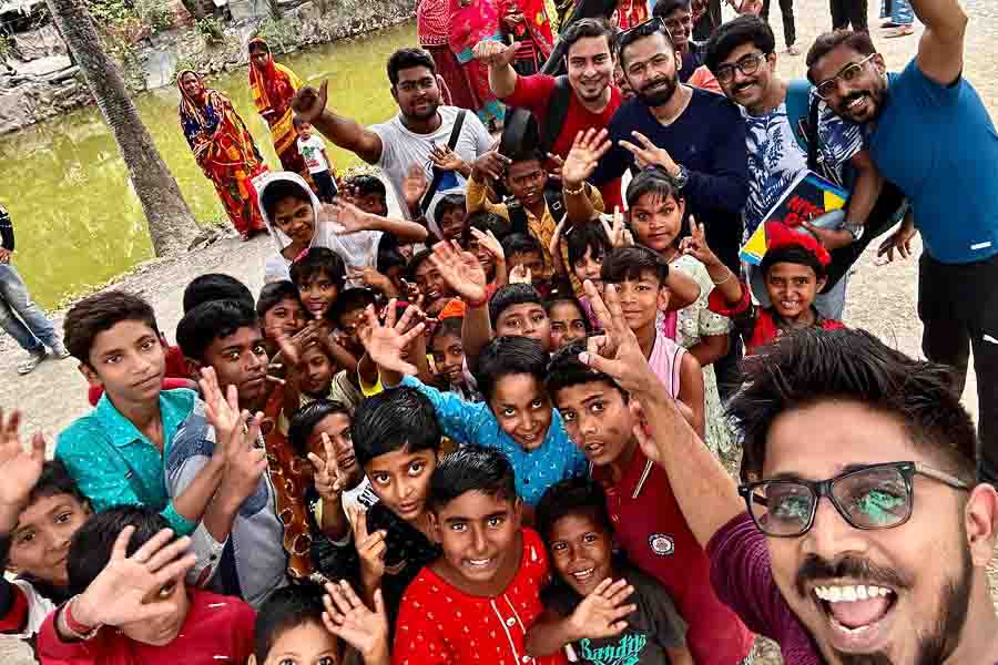 Members of Goshai Gang and the production crew with kids from Sopan Welfare Foundation during the shoot of their new single in Sarberia.
