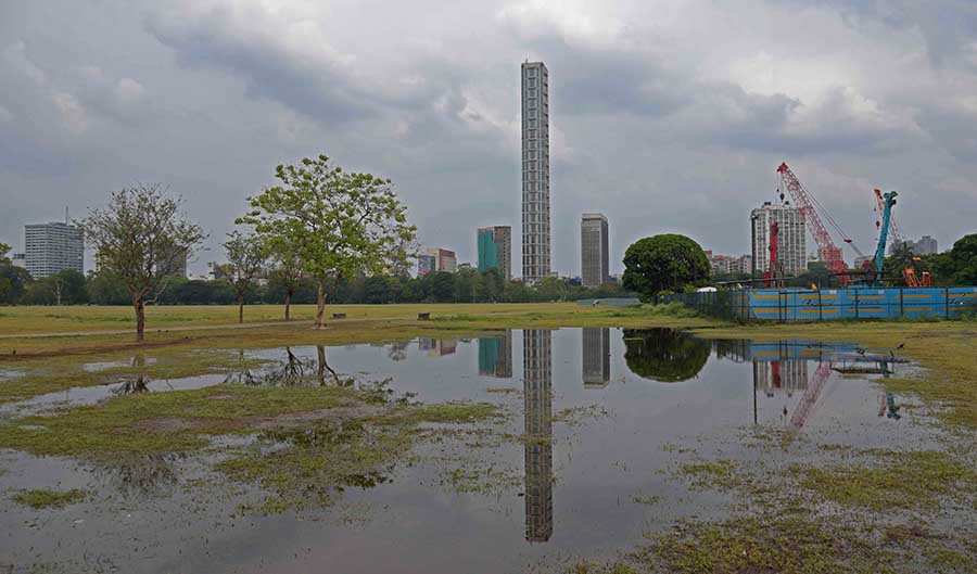 A reflection of The 42 falls in a puddle on the Maidan on Tuesday 