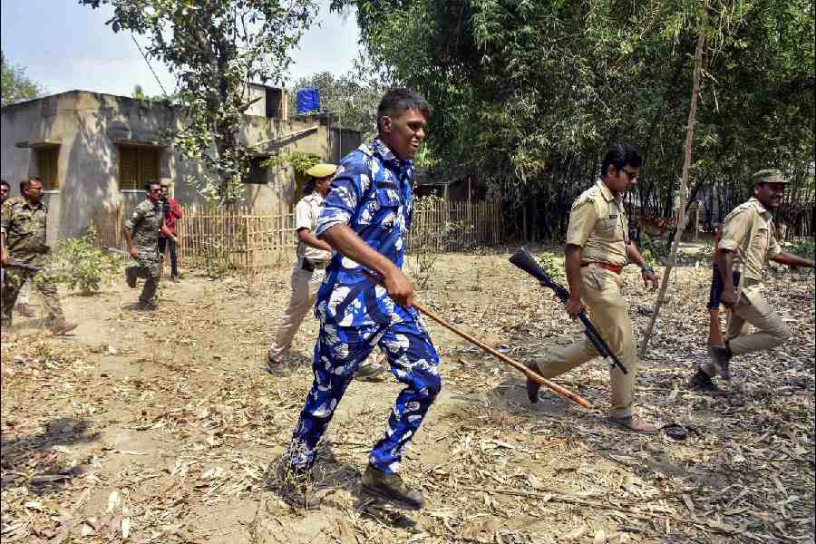 Security forces personnel disperse miscreants near a polling station during the 3rd phase of Lok Sabha polls, in Murshidabad district.