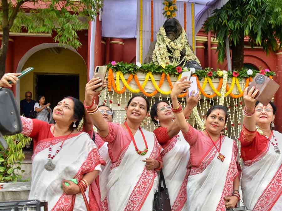 Women take selfies and groupfies with the statue of Rabindranath Tagore at Jorasanko Thakurbari