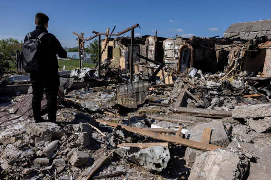 A man inspects the damage to a house after a Russian missile strike in Krasylivka, Kyiv region of Ukraine, on Wednesday