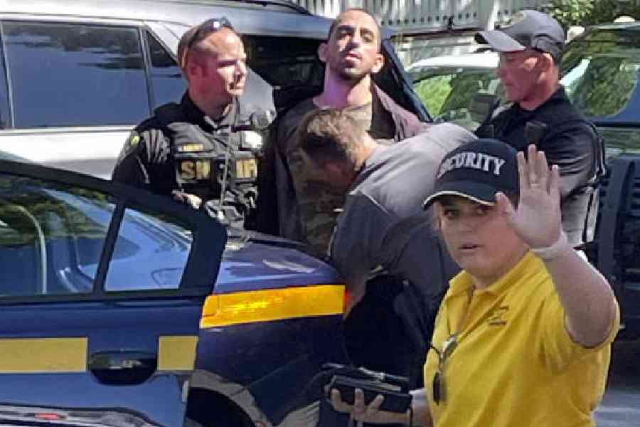Law enforcement officers detain Hadi Matar, 24, outside the Chautauqua Institution on August 12, 2022, in Chautauqua, US, after he stabbed Salman Rushdie multiple times as the latter was about to give a lecture at the institute in western New York