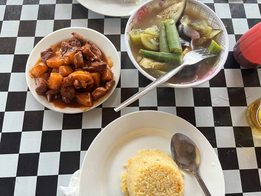 Pork menudo and fish sinigang at a small roadside eatery on the way to Alegria Beach in the north of Siargao. Sinigang is a sour and savoury dish