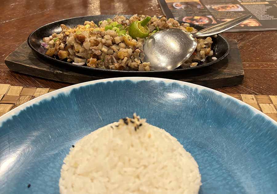 Pork sisig at a local restaurant. Sisig is a crunchy dish made with crispy fried pork cheek, onions and other vegetables. You have it with rice or as a ‘chakhna’ with drinks