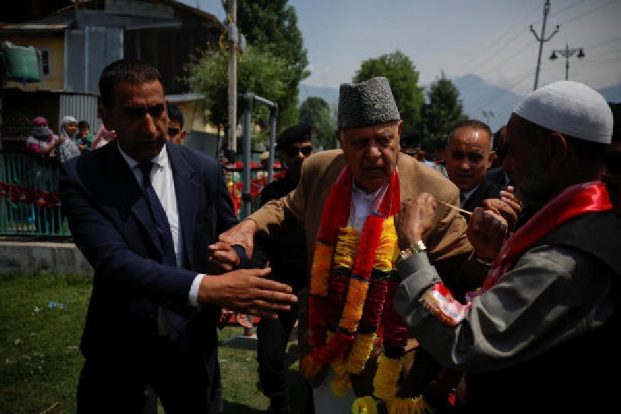 Supporters greet Farooq Abdullah at an election rally in Srinagar on Saturday