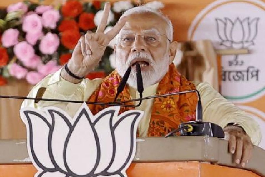 Prime Minister Narendra Modi addresses supporters during a public meeting for the Lok Sabha elections in Howrah on Sunday