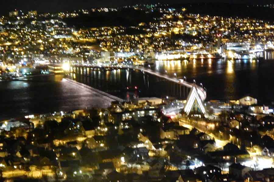 'View of Tromso from where I waited during the hike. The Arctic Cathedral (triangular structure at the start of the bridge)'