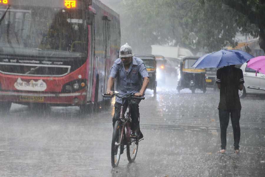 Navi Mumbai: Vehicles move on a road amid rain, at Vashi, in Navi Mumbai