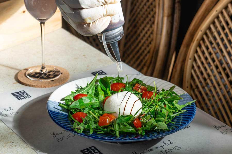 Aptly called Boo-rrata, this salad comes as a pleasant surprise with its soft and fresh Burrata