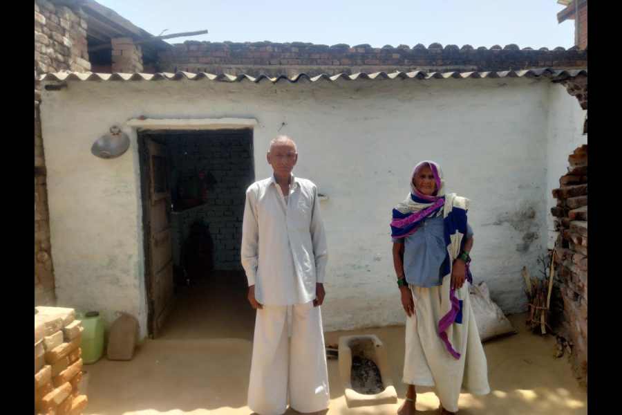 Bhojraj and his wife Shagbati in front of their asbestos-roofed, single-room dwelling in Nagla Mahadev village, Uttar Pradesh.