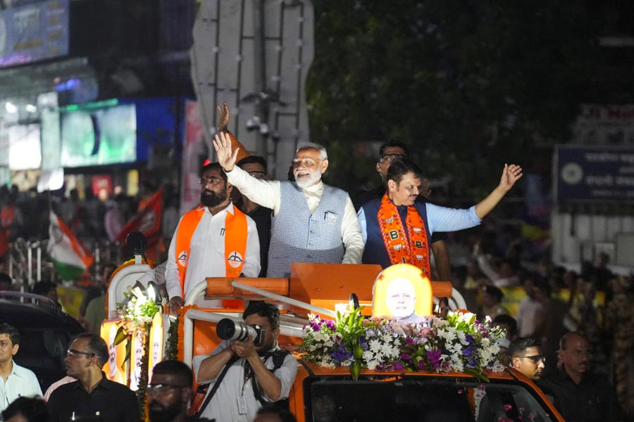 Prime Minister Narendra Modi waves towards his supporters during a roadshow as part of an election campaign, in Mumbai, India, May 15, 2024.