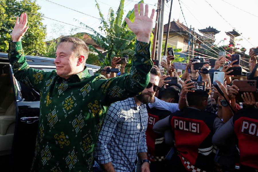 Elon Musk, chief executive officer of SpaceX and Tesla, reacts to the media as he arrives to launch SpaceX's Starlink internet service in Indonesia at a sub district community health center