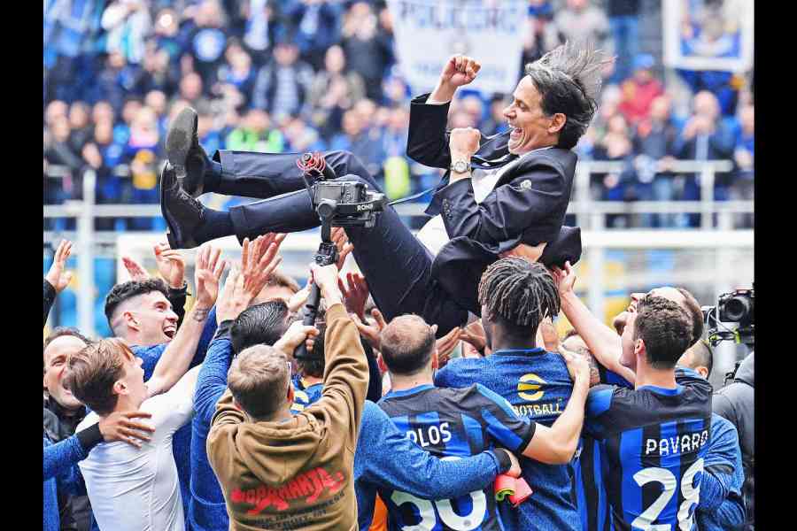 Inter Milan players lift coach Simone Inzaghi and celebrate after the match against Torino, when they were announced Serie A champions