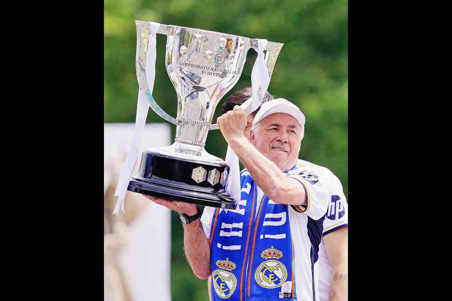 Real Madrid coach Carlo Ancelotti lifts the LaLiga trophy during the celebration after becoming champions this season