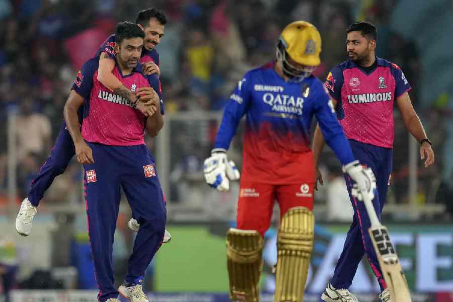 Yuzvendra Chahal of Rajasthan Royals piggybacks Man of the Match Ravichandran Ashwin after the latter’s dismissal of Royal Challengers Bengaluru’s Glenn Maxwell (not in picture) during IPL 2024’s Eliminator at the Narendra Modi Stadium in Ahmedabad on Wednesday.