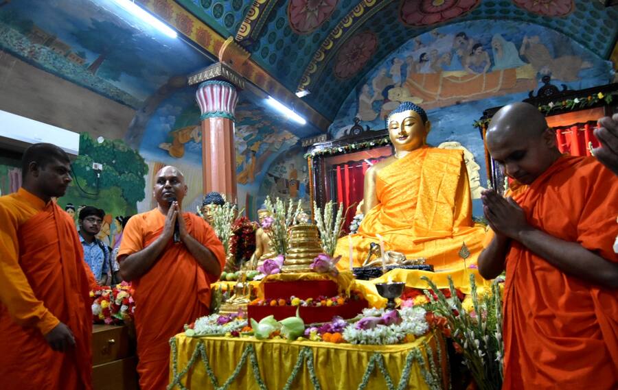 Monks lead the prayers and puja at the Mahabodhi Society of India