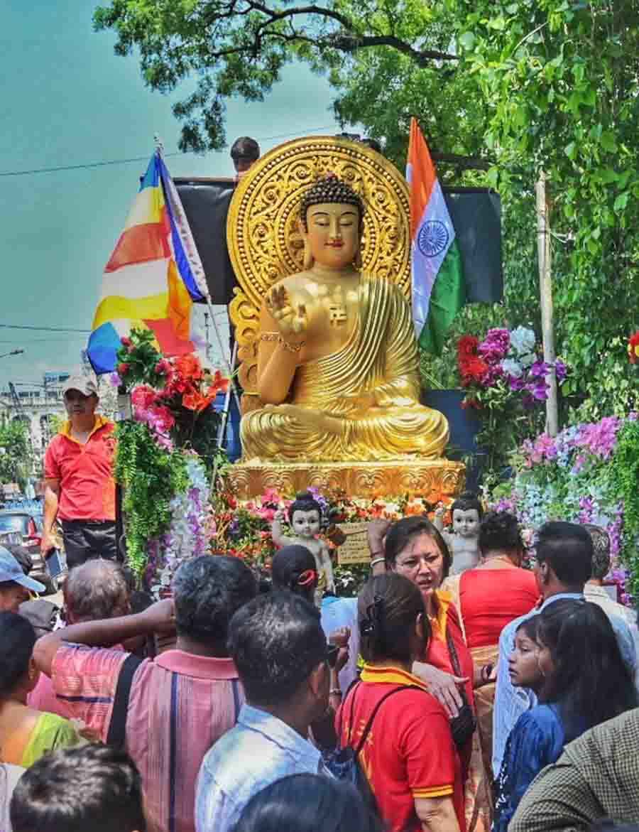 Devotees accompany colourful plateaux carrying idols of Lord Buddha in the Maidan area 