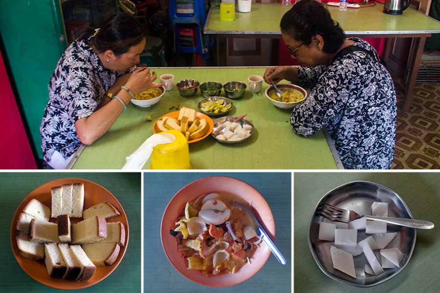 Two local residents enjoy their meal of (from left) slice cake, non-vegetarian khowsuey and China grass pudding.  